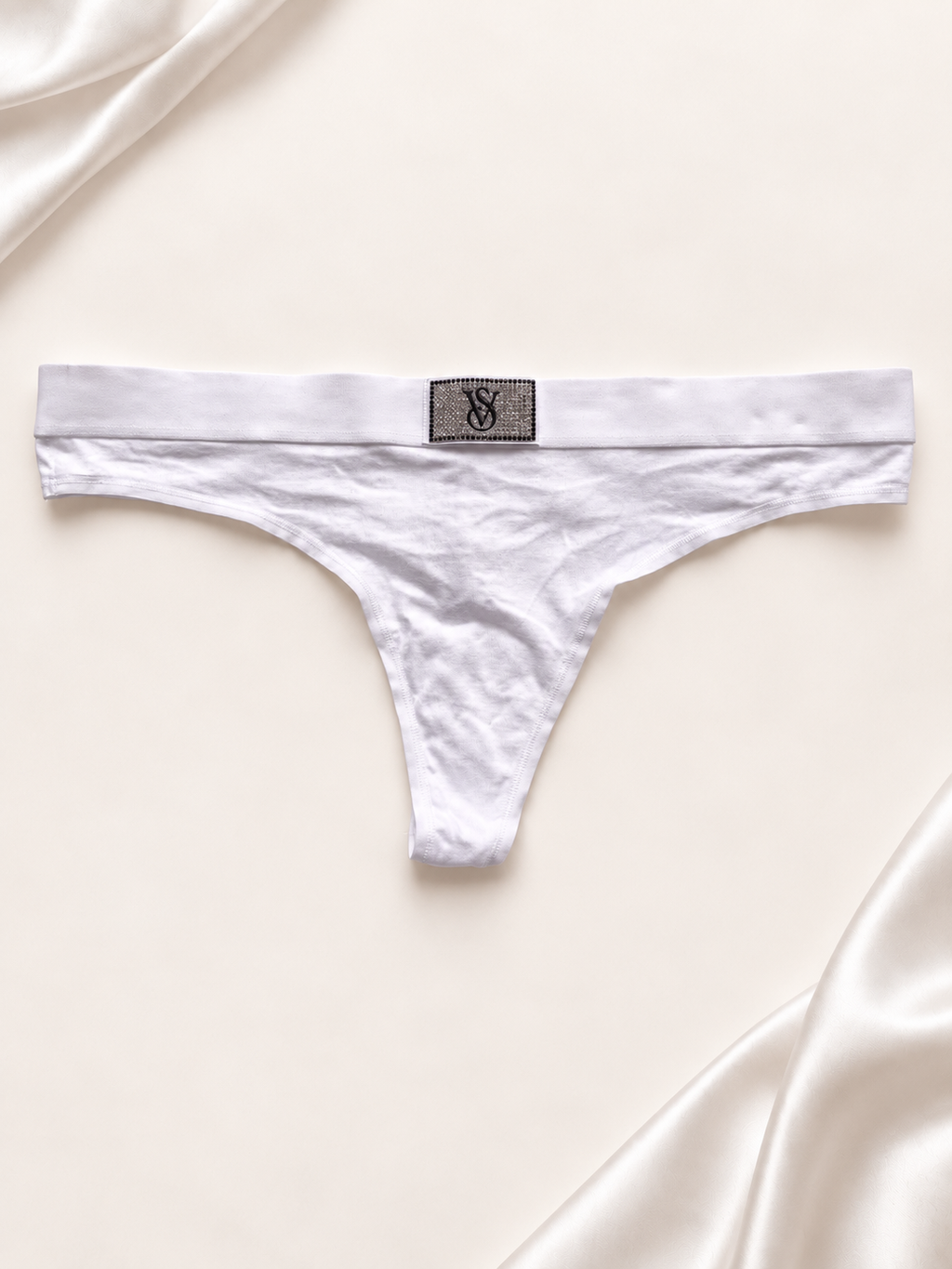 Panti blanco con logo central en la cintura, vista dorso