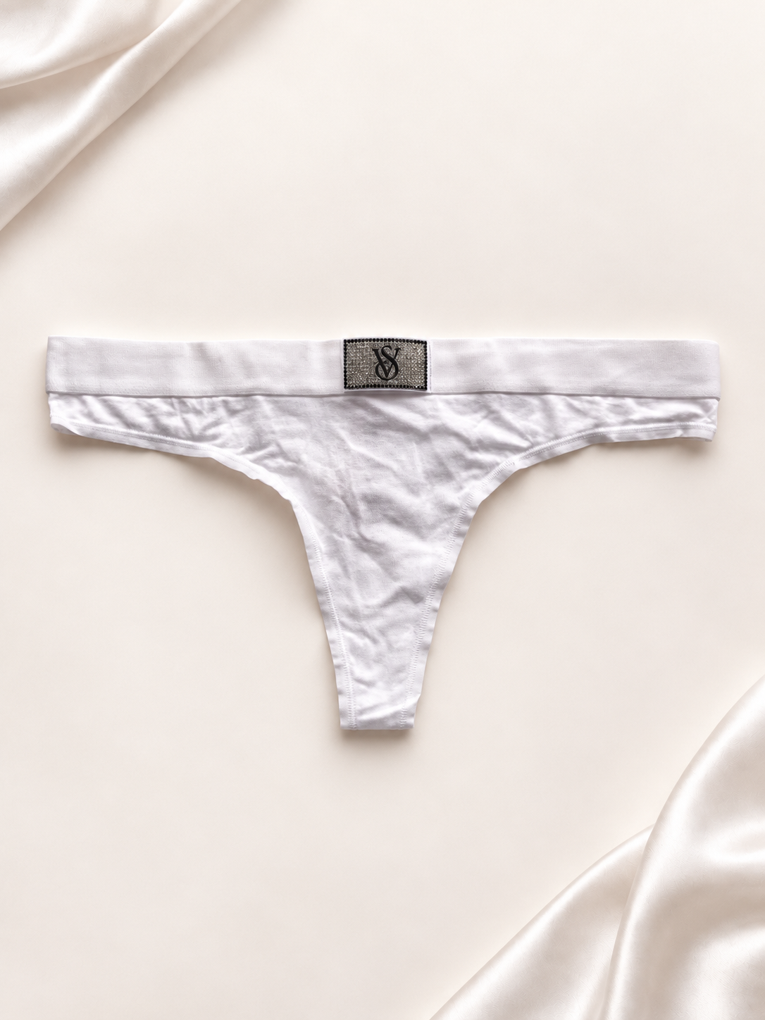 Panti blanco con logo central en la cintura, vista frente