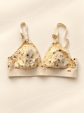 Bralette V'S de Encaje Marfil con Corazones Dorados, vista frontal sobre fondo crema de líneas suaves