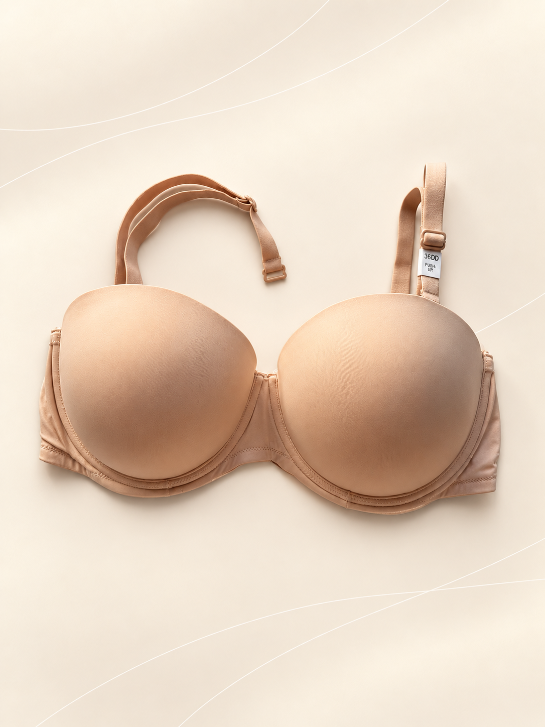 Corpiño Pink Strapless - Push Up Liso, Beige, vista frontal sobre fondo crema de líneas suaves