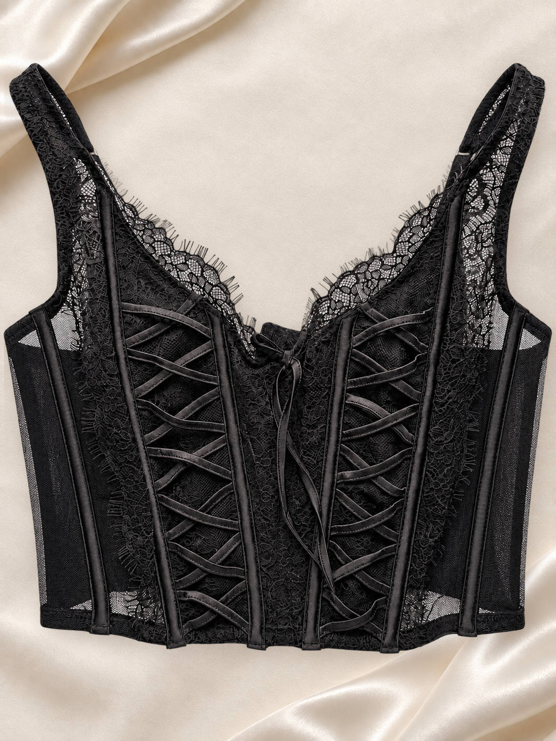 Corset Bustier Negro de Encaje con Detalles Cruzados, vista frontal sobre fondo marfil