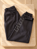 Jogger PINK negro con logo brillante, vista frontal